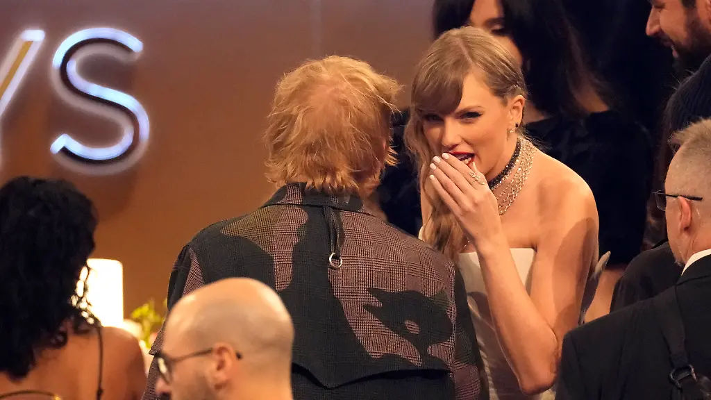 Ed-Sheeran-left-and-Taylor-Swift-speak-in-the-audience-during-the-66th-annual-Grammy-Awards-on-Sunday-Feb-4-2024-in-Los-Angeles