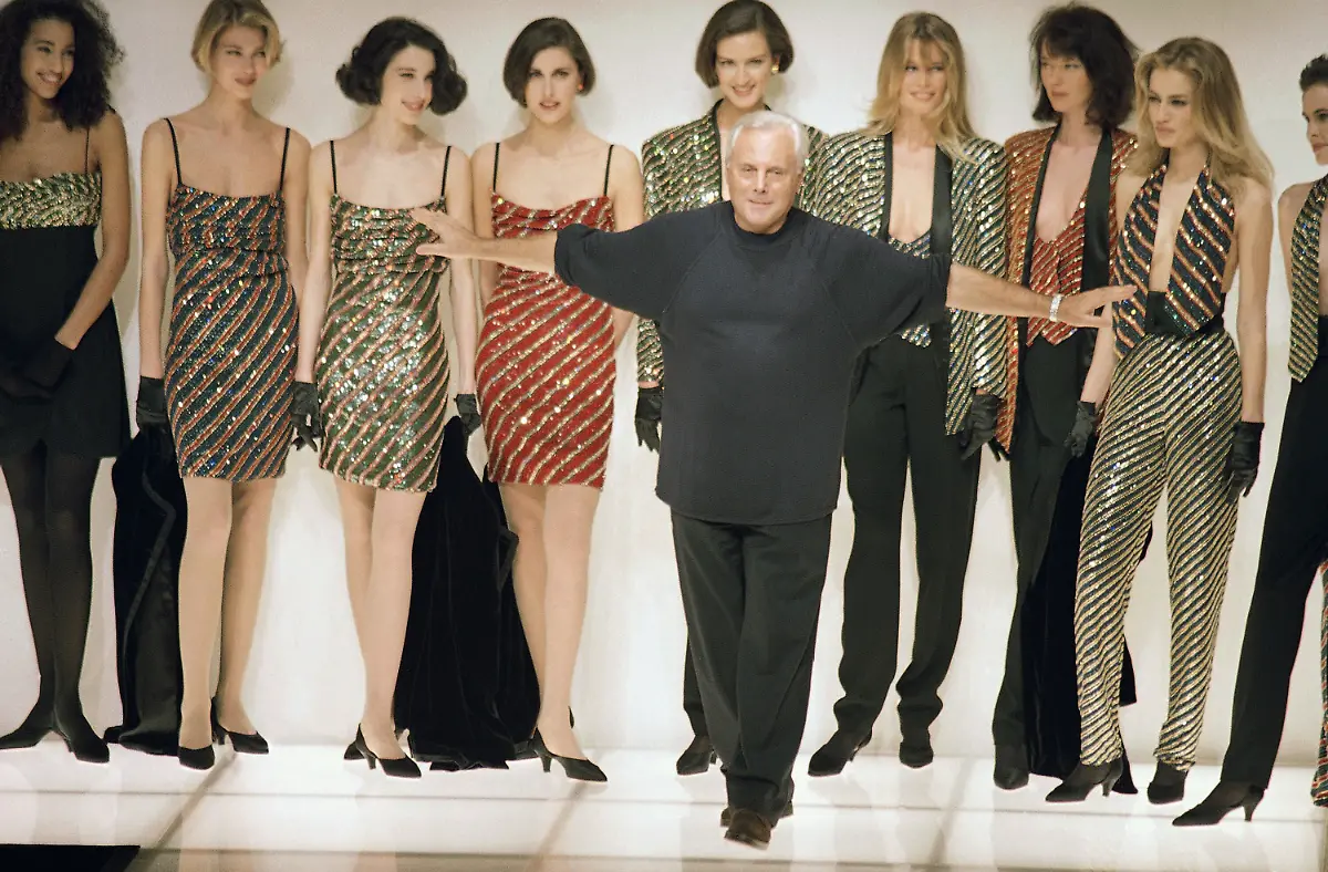 Italian-fashion-designer-Giorgio-Armani-acknowledges-the-applause-from-buyers-and-journalists-as-he-makes-his-appearance-on-the-catwalk-after-the-presentation-of-his-ready-to-wear-collection-for-Fall-Winter-1991-92-on-Thursday-March-8-1991-in-Milan
