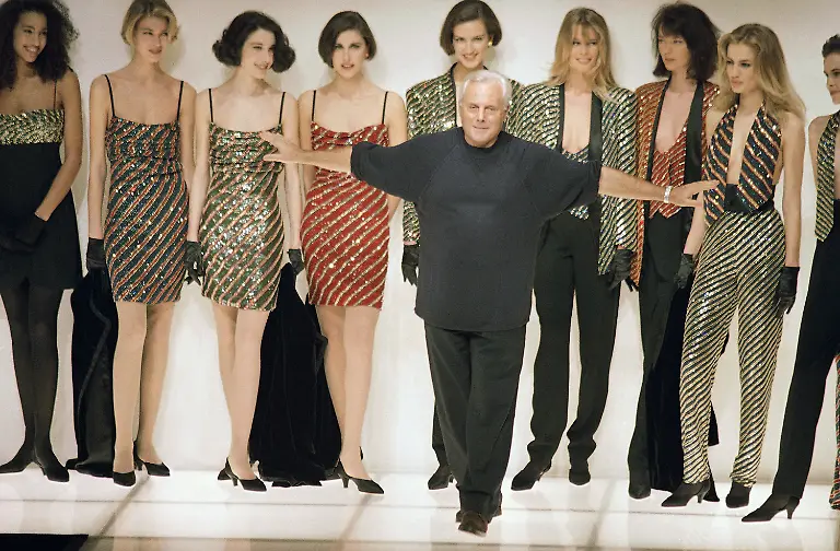 Italian-fashion-designer-Giorgio-Armani-acknowledges-the-applause-from-buyers-and-journalists-as-he-makes-his-appearance-on-the-catwalk-after-the-presentation-of-his-ready-to-wear-collection-for-Fall-Winter-1991-92-on-Thursday-March-8-1991-in-Milan
