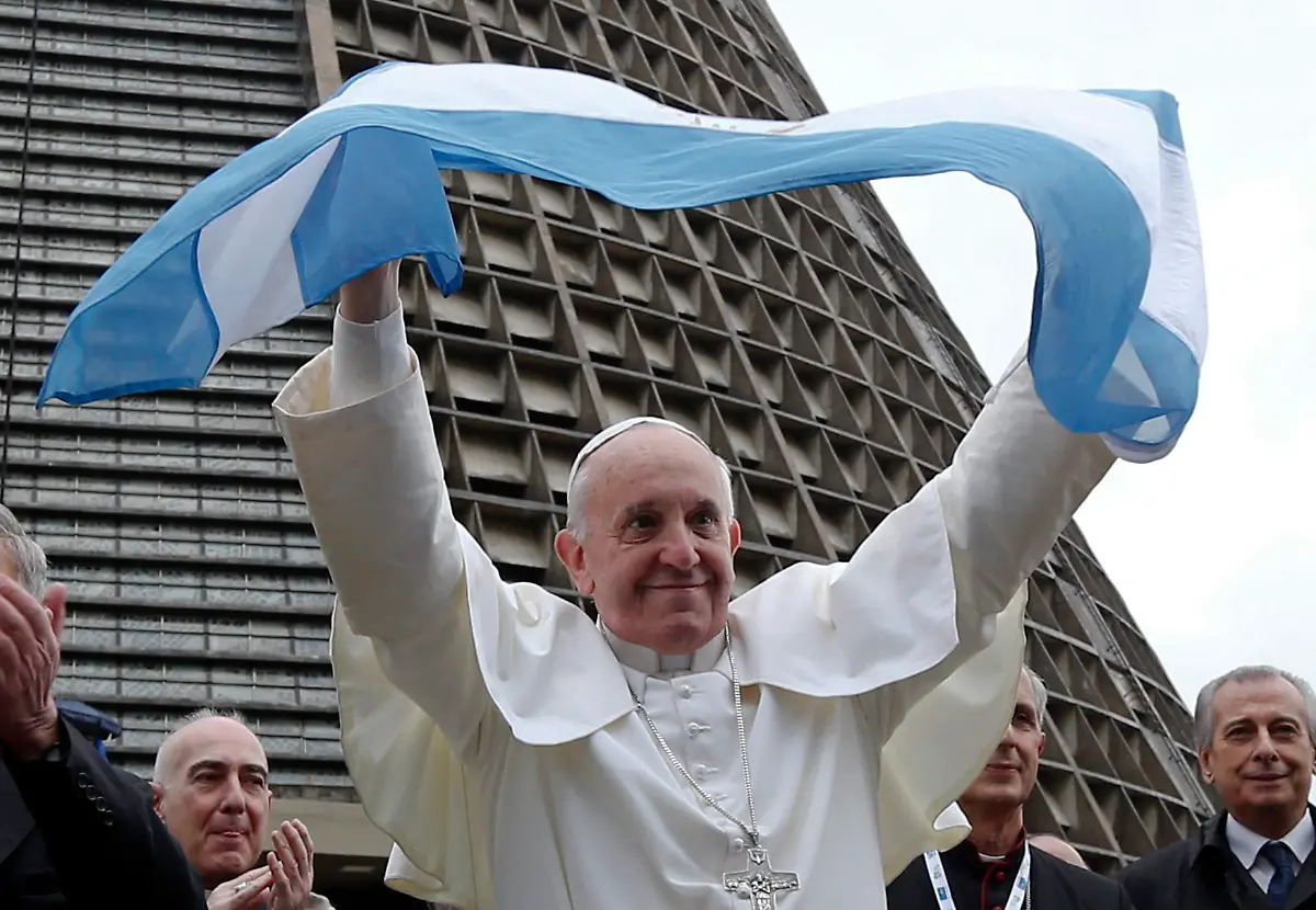 Pope-Francis-holds-up-an-Argentine-flag-outside-the-Metropolitan-Cathedral-in-Rio-de-Janeiro-Brazil-July-25-2013-Francis-added-a-last-minute-tweak-to-his-busy-schedule-meeting-with-pilgrims-from-his-native-Argentina-at-Rio-s-cathedral-Thursday-afternoon-He-told-the-youngsters-to-get-out-into-the-streets-and-spread-their-faith-saying-that-a-church-that-doesn-t-go-out-and-preach-becomes-a-simple-NGO-or-nongovernmental-organization-And-the-church-cannot-be-an-NGO-he-said-to-applause