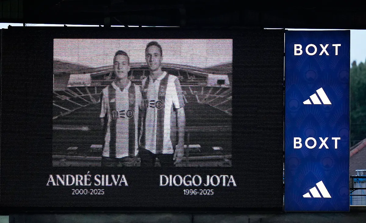A-giant-screen-displays-an-image-of-the-late-Diogo-Jota-and-Andre-Silva-as-Leeds-and-Everton-players-stand-for-a-minute-s-silence-in-memory-of-them-during-an-English-Premier-League-soccer-match-between-Leeds-United-and-Everton-at-Elland-Road-in-Leeds-England-Monday-Aug-18-2025