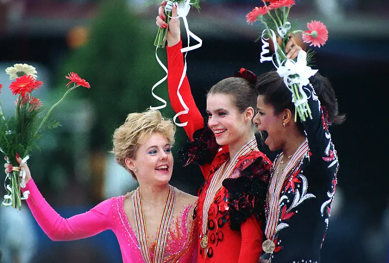 FILE-In-this-March-26-1988-file-photo-gold-medalist-Katarina-Witt-of-East-Germany-is-flanked-by-silver-medalist-Elizabeth-Manley-left-of-Canada-and-bronze-medalist-Debi-Thomas-of-the-United-States-during-the-medal-ceremony-at-the-World-Figure-Skating-Championships-in-Budapest-Hungary-As-the-Olympics-draws-near-the-sport-of-figure-skating-will-once-again-be-pumped-into-U-S-homes-in-primetime-But-absent-from-the-competition-is-the-kind-of-rivalry-that-has-elevated-the-sport-over-the-years