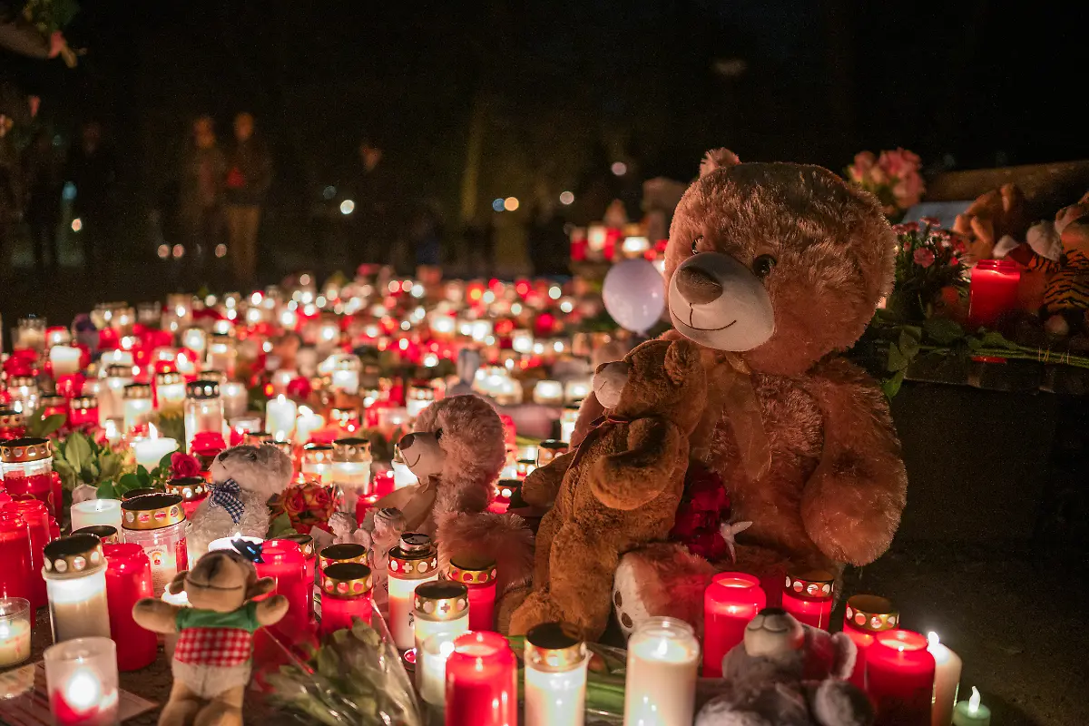 Ein-Teddybaer-und-zahlreiche-Kerzen-stehen-zum-Gedenken-an-die-toedliche-Messerattacke-im-Park-Schoental-am-Boden-Das-Buendnis-Aschaffenburg-bleibt-bunt-veranstaltet-ein-stilles-Gedenken-im-Park-Schoental-Mutmasslicher-Taeter-des-Messerangriffs-im-Park-Schoental-wurde-heute-dem-Haftrichter-vorgefuehrt