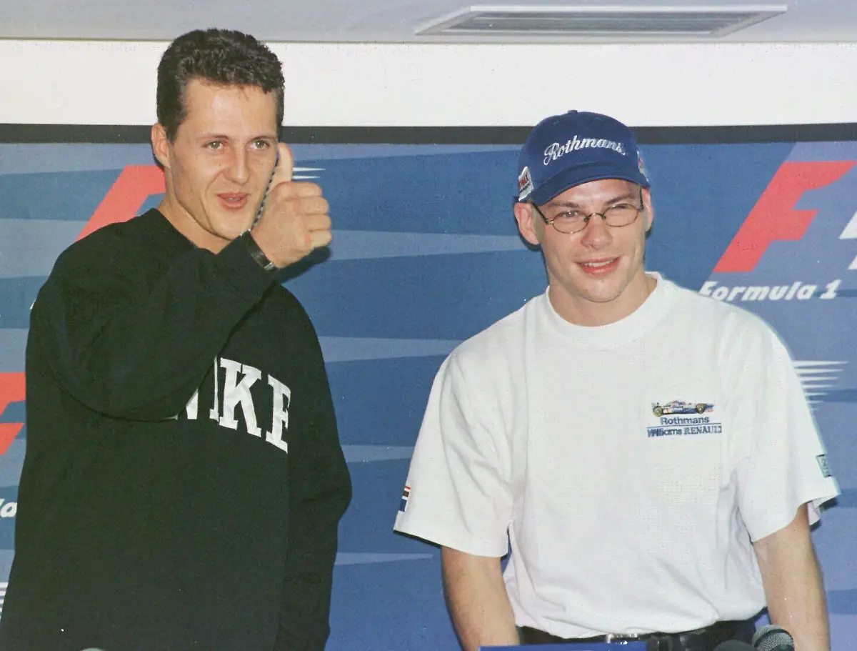 Germany-s-Michael-Schumacher-who-drives-for-Ferrari-left-gives-the-thumbs-up-while-posing-with-Canada-s-Jacques-Villeneuve-of-Williams-Renault-before-a-press-conference-in-Jerez-Thursday-October-23-1997-as-the-two-arrived-for-the-final-Formula-One-race-of-the-1996-97-season-on-Sunday-Villeneuve-has-one-point-deficit-from-Championship-leader-Schumacher