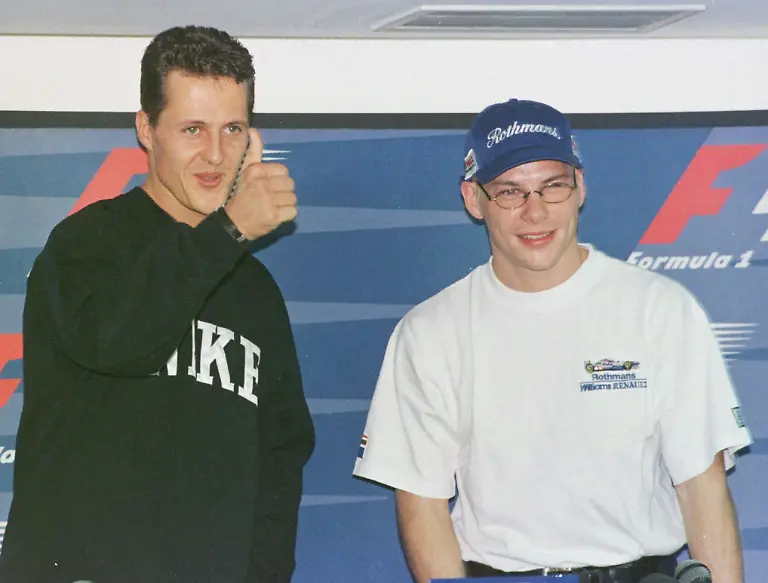 Germany-s-Michael-Schumacher-who-drives-for-Ferrari-left-gives-the-thumbs-up-while-posing-with-Canada-s-Jacques-Villeneuve-of-Williams-Renault-before-a-press-conference-in-Jerez-Thursday-October-23-1997-as-the-two-arrived-for-the-final-Formula-One-race-of-the-1996-97-season-on-Sunday-Villeneuve-has-one-point-deficit-from-Championship-leader-Schumacher
