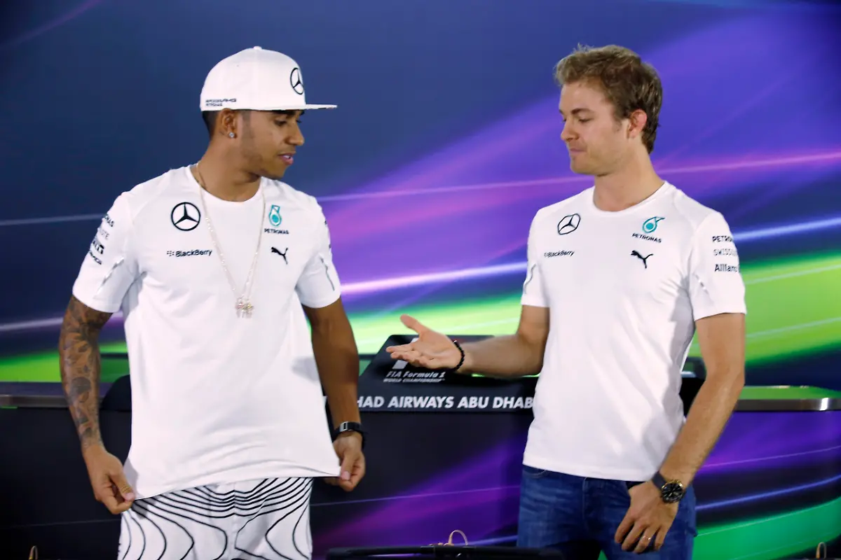 In-this-Thursday-Nov-20-2014-photo-Mercedes-driver-Lewis-Hamilton-of-Britain-left-looks-at-his-teammate-Nico-Rosberg-of-Germany-before-shaking-hand-prior-to-a-news-conference-at-the-Yas-Marina-racetrack-in-Abu-Dhabi-United-Arab-Emirates-Rosberg-s-announcement-on-Friday-Dec-2-2016-that-he-was-retiring-at-the-age-of-31-five-days-after-earning-his-first-Formula-One-world-championship-shocked-the-world-of-motor-racing
