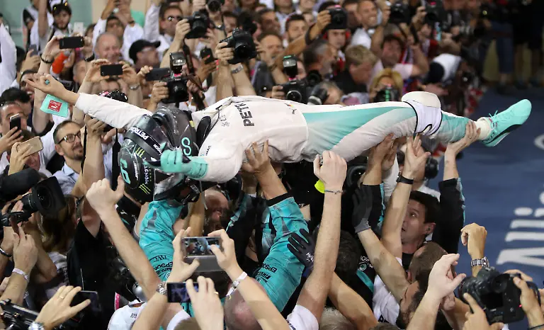 2016-Christmas-Sport-Package-File-photo-dated-27-11-2016-Nico-Rosberg-is-held-aloft-in-celebration-of-a-first-Formula-One-world-title-after-a-close-fought-battle-with-Mercedes-team-mate-Lewis-Hamilton-The-German-who-needed-to-finish-in-the-top-three-in-the-final-race-of-the-season-in-Abu-Dhabi-survived-a-dramatic-conclusion-to-cross-the-line-second-behind-Hamilton-and-win-his-maiden-crown-by-five-points-despite-winning-one-fewer-race-Issue-date-Thursday-December-15-2016-See-PA-story-SPORT-Christmas-Pictures-Photo-credit-should-read-David-Davies-PA-Wire
