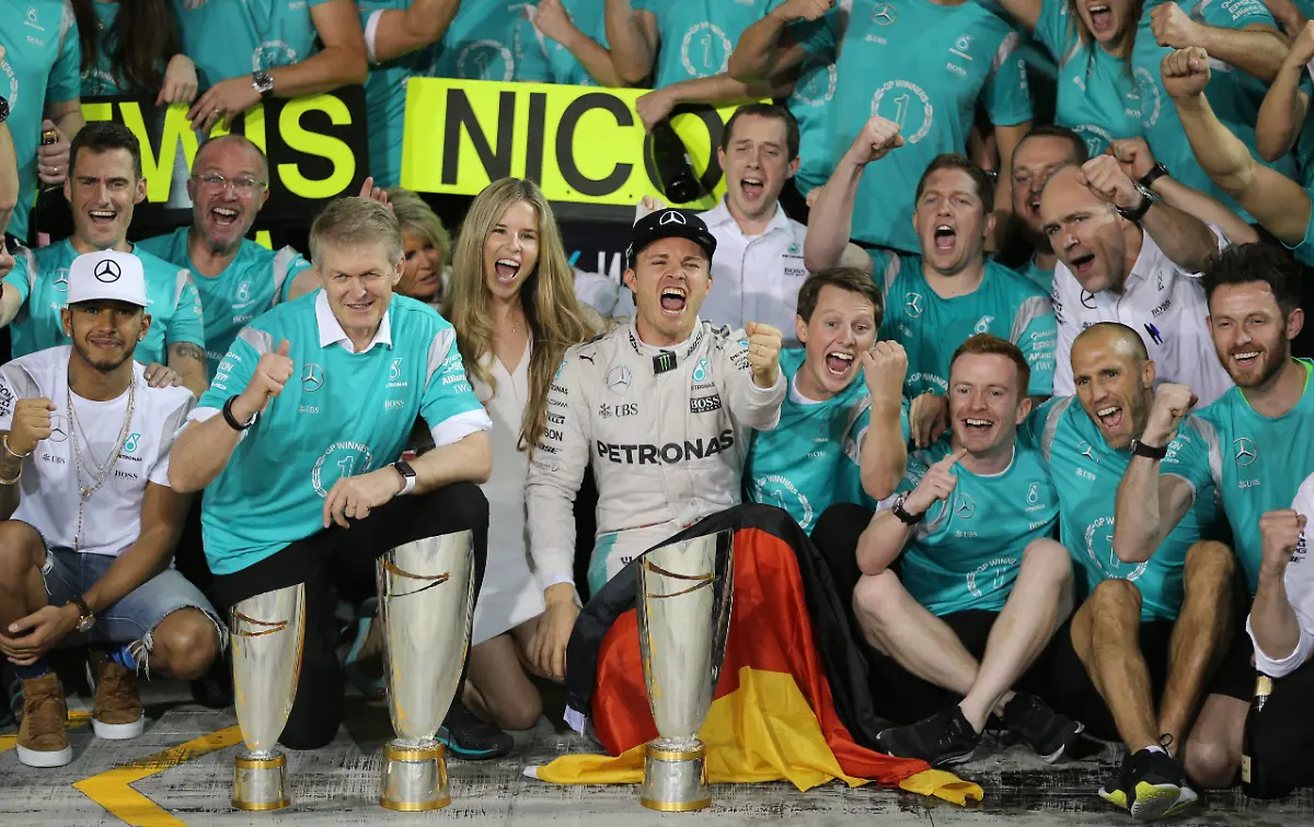 Mercedes-driver-Nico-Rosberg-of-Germany-center-and-Mercedes-driver-Lewis-Hamilton-of-Britain-left-are-celebrated-by-their-team-in-the-team-garage-after-the-Emirates-Formula-One-Grand-Prix-at-the-Yas-Marina-racetrack-in-Abu-Dhabi-United-Arab-Emirates-Sunday-Nov-27-2016-Hamilton-finished-first-in-the-event-and-Rosberg-placed-second-as-well-as-becoming-the-2016-world-champion