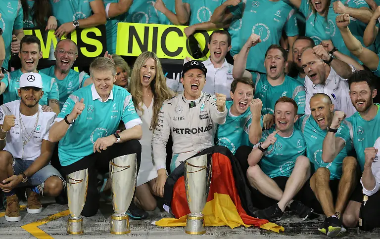 Mercedes-driver-Nico-Rosberg-of-Germany-center-and-Mercedes-driver-Lewis-Hamilton-of-Britain-left-are-celebrated-by-their-team-in-the-team-garage-after-the-Emirates-Formula-One-Grand-Prix-at-the-Yas-Marina-racetrack-in-Abu-Dhabi-United-Arab-Emirates-Sunday-Nov-27-2016-Hamilton-finished-first-in-the-event-and-Rosberg-placed-second-as-well-as-becoming-the-2016-world-champion
