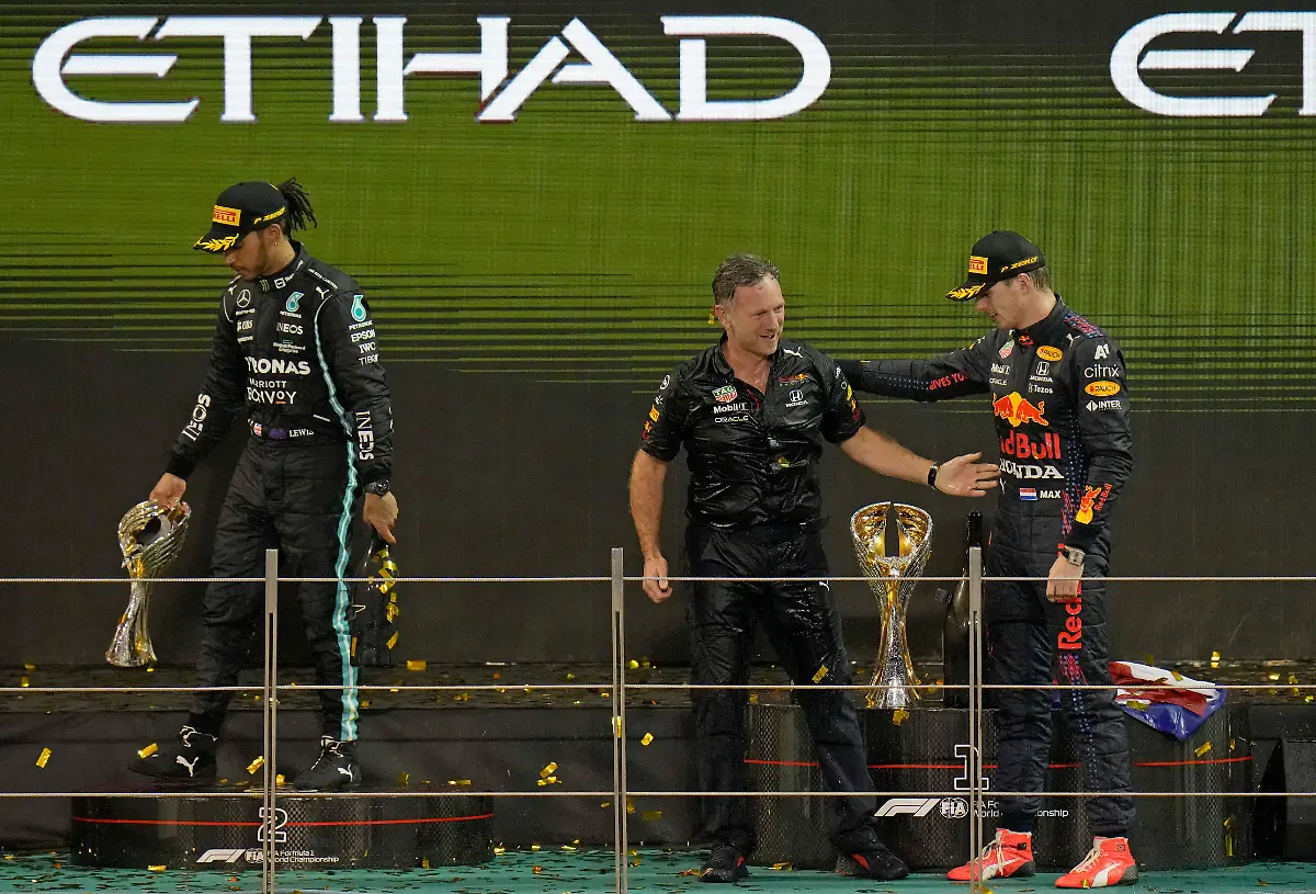 FILE-Red-Bull-team-chief-Christian-Horner-center-celebrates-with-his-driver-Max-Verstappen-of-the-Netherlands-after-winning-the-Formula-One-Abu-Dhabi-Grand-Prix-in-Abu-Dhabi-United-Arab-Emirates-Dec-12-2021-Max-Verstappen-ripped-a-record-eighth-title-away-from-Lewis-Hamilton-left-with-a-pass-on-the-final-lap-of-the-Abu-Dhabi-GP-to-close-one-of-the-most-thrilling-Formula-One-seasons-in-years-as-the-first-Dutch-world-champion