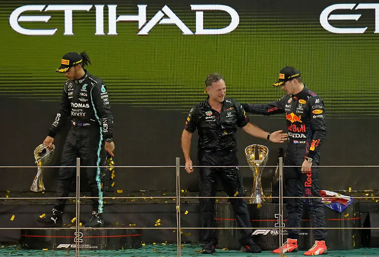 FILE-Red-Bull-team-chief-Christian-Horner-center-celebrates-with-his-driver-Max-Verstappen-of-the-Netherlands-after-winning-the-Formula-One-Abu-Dhabi-Grand-Prix-in-Abu-Dhabi-United-Arab-Emirates-Dec-12-2021-Max-Verstappen-ripped-a-record-eighth-title-away-from-Lewis-Hamilton-left-with-a-pass-on-the-final-lap-of-the-Abu-Dhabi-GP-to-close-one-of-the-most-thrilling-Formula-One-seasons-in-years-as-the-first-Dutch-world-champion