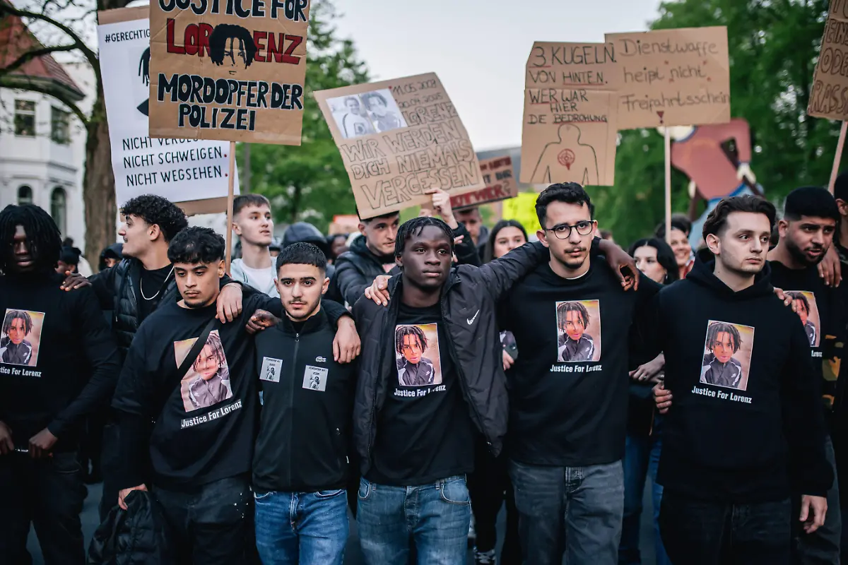 OLDENBURG-GERMANY-APRIL-25-People-gather-to-pay-tribute-to-a-21-year-old-black-man-named-Lorenz-A-who-was-killed-last-Sunday-by-German-police-on-April-25-2025-in-Oldenburg-Germany-Thousands-of-protesters-gathered-in-the-city-center-to-demand-justice-for-the-black-victim-who-was-shot-4-times-by-a-policeman-from-behind-after-he-allegedly-used-tear-gas