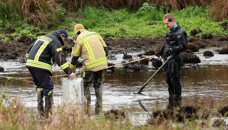 Am-Fundort-des-getoeteten-achtjaehrigen-Fabian-aus-Guestrow-an-einem-kleinen-Tuempel-bei-Klein-Upahl-pumpt-die-Feuerwehr-das-Wasser-ab-waehrend-ein-Polizist-mit-einem-Detektor-in-Aktion-ist-Laut-vorlaeufigem-Obduktionsergebnis-ist-der-Grundschueler-Opfer-eines-Gewaltverbrechens-geworden