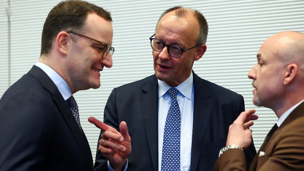 German-Chancellor-Friedrich-Merz-speaks-to-Christian-Democratic-Union-s-Jens-Spahn-the-CDU-CSU-parliamentary-group-leader-and-member-of-the-German-Bundestag-Alexander-Hoffmann-on-the-day-of-a-CDU-CSU-fraction-meeting-in-Berlin-Germany-December-2-2025
