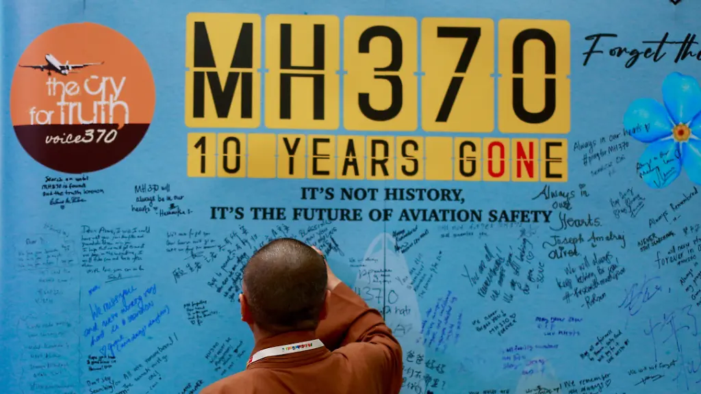 Visitors-are-writing-messages-at-the-Day-of-Remembrance-for-MH370-in-Petaling-Jaya-Malaysia-on-March-3-2024-Today-marks-the-10th-anniversary-of-the-disappearance-of-Flight-MH370-a-Boeing-777-aircraft-with-239-people-on-board-which-vanished-from-radar-screens-on-March-8-2014-while-flying-from-Kuala-Lumpur-to-Beijing