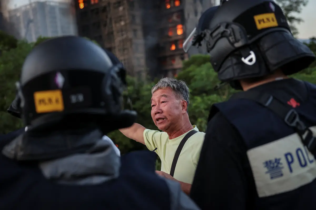 Wong-71-tells-police-the-unit-number-where-he-claims-his-wife-is-trapped-inside-Wang-Fuk-Court-housing-complex-during-a-deadly-fire-in-Tai-Po-Hong-Kong-China-November-26-2025-REUTERS-Tyrone-Siu-SEARCH-HONG-KONG-FIRE-PICTURE-FOR-THIS-STORY-SEARCH-WIDER-IMAGE-FOR-ALL-STORIES