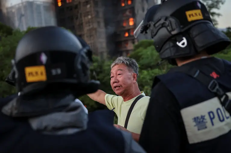 Wong-71-tells-police-the-unit-number-where-he-claims-his-wife-is-trapped-inside-Wang-Fuk-Court-housing-complex-during-a-deadly-fire-in-Tai-Po-Hong-Kong-China-November-26-2025-REUTERS-Tyrone-Siu-SEARCH-HONG-KONG-FIRE-PICTURE-FOR-THIS-STORY-SEARCH-WIDER-IMAGE-FOR-ALL-STORIES