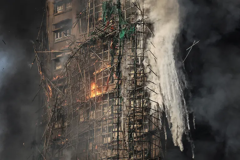 Smoke-rises-while-flames-burn-bamboo-scaffolding-on-a-building-at-Wang-Fuk-Court-housing-estate-in-Tai-Po-Hong-Kong-China-November-26-2025-REUTERS-Tyrone-Siu-SEARCH-HONG-KONG-FIRE-PICTURE-FOR-THIS-STORY-SEARCH-WIDER-IMAGE-FOR-ALL-STORIES