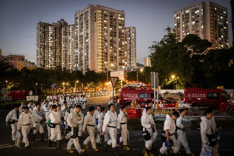 Members-of-the-Police-Disaster-Victims-Identification-Unit-walk-near-residential-blocks-at-the-Wang-Fuk-Court-housing-complex-following-a-deadly-fire-in-Tai-Po-Hong-Kong-China-November-29-2025-REUTERS-Tyrone-Siu-SEARCH-HONG-KONG-FIRE-PICTURE-FOR-THIS-STORY-SEARCH-WIDER-IMAGE-FOR-ALL-STORIES