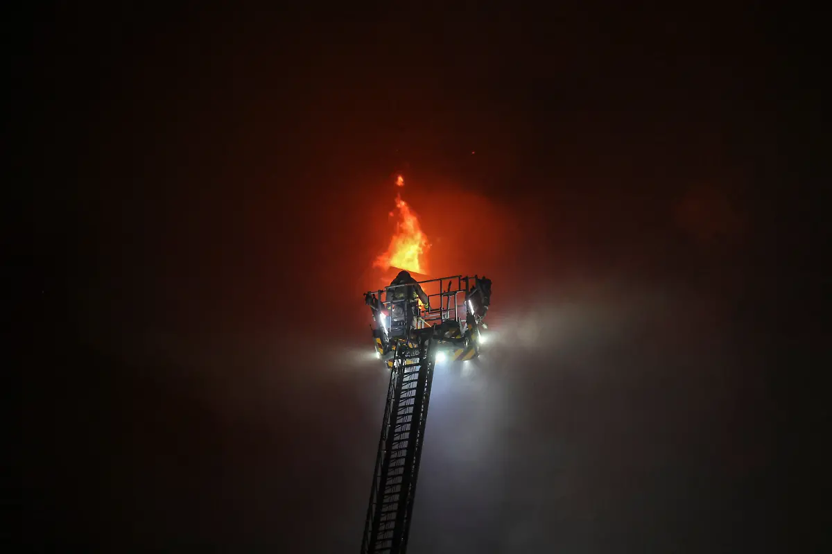 A-firefighter-stands-on-an-aerial-ladder-as-flames-and-smoke-billow-from-a-residential-unit-inside-a-block-at-Wang-Fuk-Court-housing-complex-during-a-deadly-fire-in-Tai-Po-Hong-Kong-China-November-26-2025-REUTERS-Tyrone-Siu-SEARCH-HONG-KONG-FIRE-PICTURE-FOR-THIS-STORY-SEARCH-WIDER-IMAGE-FOR-ALL-STORIES