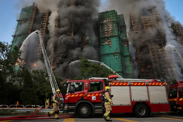 Firefighters-walk-near-the-site-of-a-major-fire-at-Wang-Fuk-Court-housing-complex-during-a-deadly-fire-in-Tai-Po-Hong-Kong-China-November-26-2025-REUTERS-Tyrone-Siu-SEARCH-HONG-KONG-FIRE-PICTURE-FOR-THIS-STORY-SEARCH-WIDER-IMAGE-FOR-ALL-STORIES