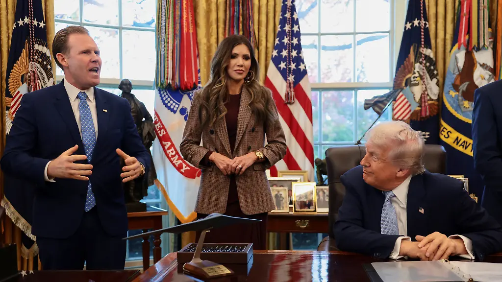 U-S-President-Donald-Trump-sits-while-Andrew-Giuliani-head-of-the-White-House-Task-Force-for-the-FIFA-World-Cup-2026-and-U-S-Homeland-Security-Secretary-Kristi-Noem-stand-by-his-side-as-he-meets-with-the-White-House-Task-Force-on-the-FIFA-World-Cup-2026-in-the-Oval-Office-at-the-White-House-in-Washington-D-C-U-S-November-17-2025