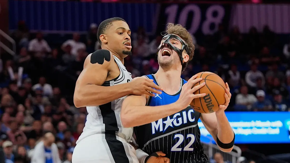 Orlando-Magic-forward-Franz-Wagner-22-is-fouled-by-San-Antonio-Spurs-forward-Keldon-Johnson-left-as-he-goes-up-for-a-shot-during-the-second-half-of-an-NBA-basketball-game-Wednesday-Dec-3-2025-in-Orlando-Fla