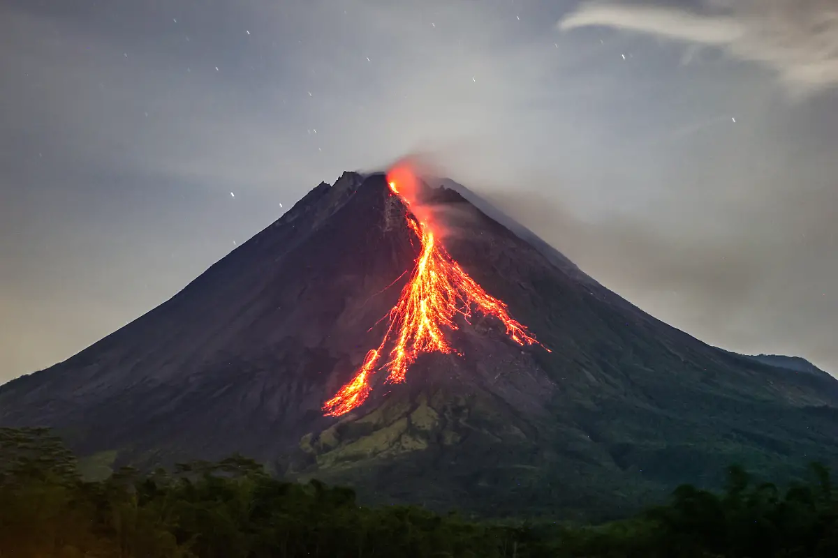 November-25-2025-Sleman-Yogyakarta-Special-Region-INDONESIA-Mount-Merapi-is-seen-spewing-hot-reddish-lava-from-its-peak-as-seen-in-Tunggul-Arum-Sleman-Yogyakarta-Tuesday-November-25-2025-Currently-Mount-Merapi-is-at-alert-level-The-Yogyakarta-Volcanology-Agency-informs-of-potential-danger-in-the-form-of-lava-avalanches-and-pyroclastic-flows-to-the-south-southwest-in-the-Boyong-River-up-to-5-km-the-Bedog-Krasak-Bebeng-Rivers-up-to-7-km-The-southeast-direction-includes-the-Woro-River-and-the-River-up-to-5-km