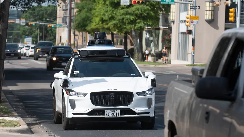 June-19-2025-Austin-Tx-United-States-Waymo-branded-robotaxis-have-become-common-on-the-downtown-streets-of-Austin-Texas-in-a-partnership-with-Uber-providing-fully-autonomous-rides-to-Austin-residents-on-June-19-2025-Waymo-uses-specially-equipped-Jaguars-and-is-competing-with-Tesla-Zoox-and-AVride-for-space-on-downtown-streets