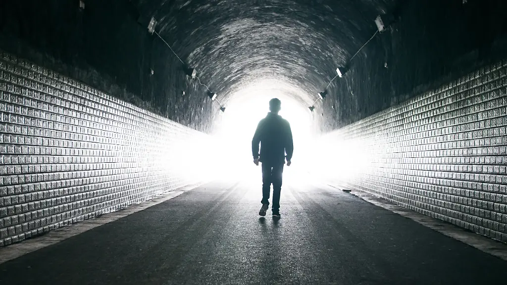 Man-walking-to-light