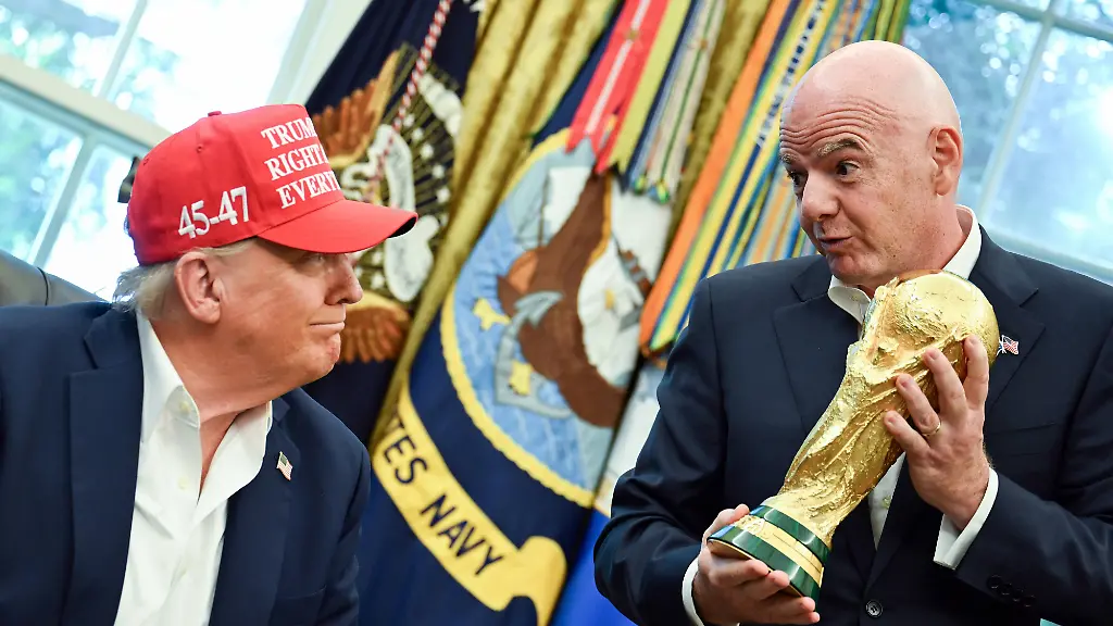 FIFA-President-Gianni-Infantino-hands-President-Donald-Trump-the-FIFA-World-Cup-trophy-after-announcing-the-2026-World-Cup-draw-will-be-held-at-the-Kennedy-Center-in-December-in-the-Oval-Office-of-the-White-House-in-Washington-DC-on-Friday-August-22-2025-The-FIFA-World-Cup-coming-to-North-America-next-summer-will-be-the-first-World-Cup-with-three-host-countries-in-the-U-S-Canada-and-Mexico-and-it-will-be-the-first-to-feature-a-48-team-field