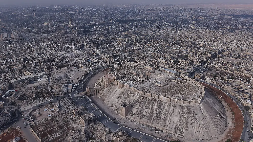 Ein-Luftbild-zeigt-die-Zerstoerung-in-der-Stadt-Aleppo-vor-dem-ersten-Jahrestag-der-Befreiung-der-Stadt-Aleppo-Eine-Rebellenallianz-unter-Fuehrung-der-Islamistengruppe-Haiat-Tahrir-al-Scham-HTS-hatte-vor-einem-Jahr-eine-ueberraschende-Offensive-gegen-die-Regierung-begonnen-und-damit-das-Ende-der-jahrzehntelangen-Herrschaft-von-Baschar-al-Assad-und-dessen-Familie-ueber-Syrien-eingelaeutet