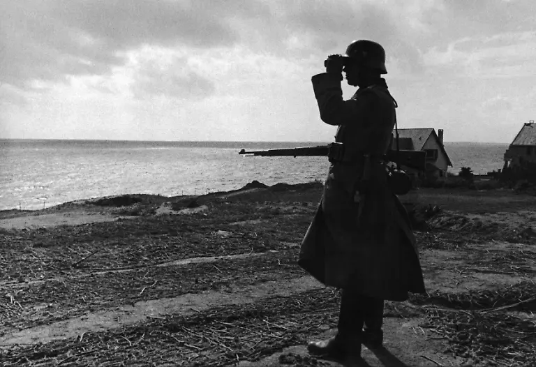 FRANCE-JUNE-01-A-Guard-Of-The-Germany-Army-Surveying-The-French-Coast-In-June-1944-In-The-Area-Around-The-Atlantic-Wall-In-Order-To-Warn-Of-The-Arrival-Of-An-Allied-Offensive-Attack