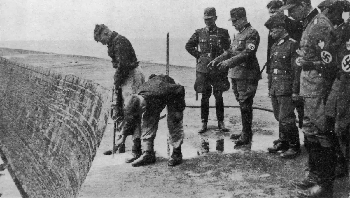 German-military-engineers-inspecting-a-quay-under-construction-circa-1943-Workers-are-installing-steel-bars-which-will-be-used-to-anchor-barbed-wire-defences-to-the-wall-The-quay-is-part-of-the-Atlantic-Wall-fortifications-built-by-Germany-along-the-western-coast-of-Europe-against-Allied-invasion