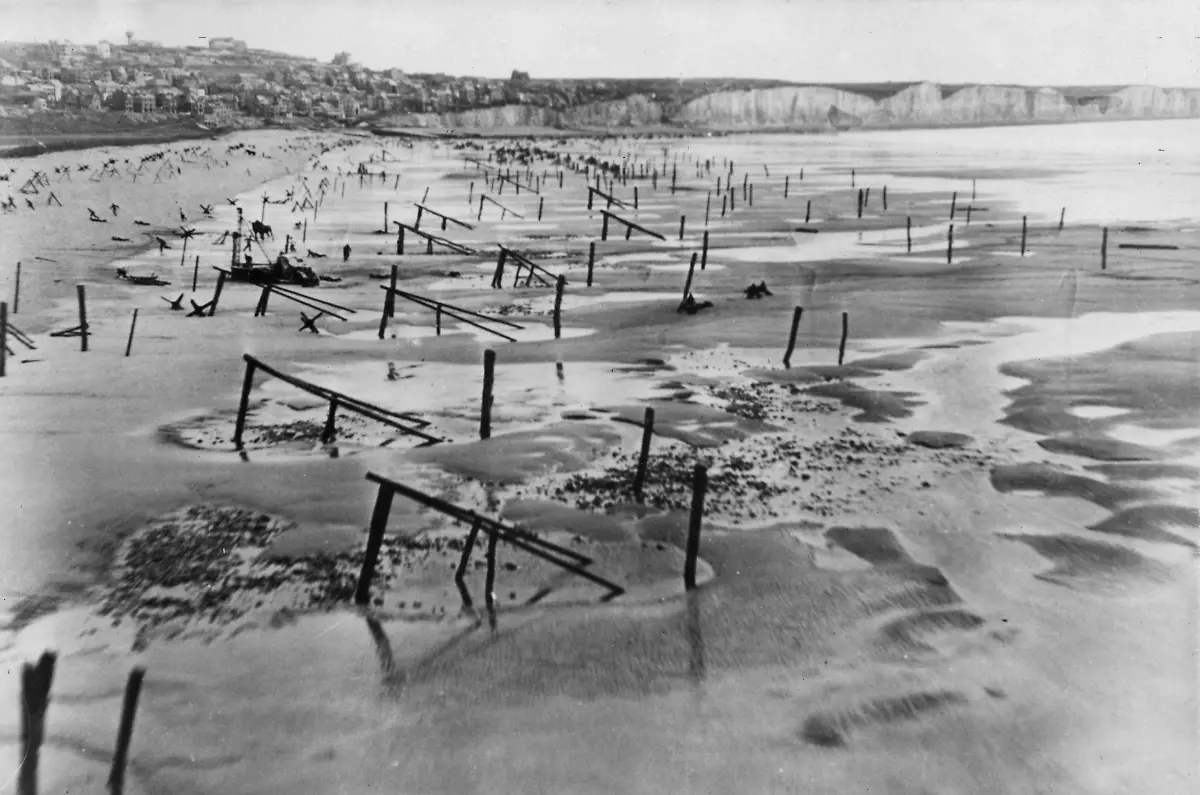 WW2-Men-and-horses-may-be-seen-working-amid-landing-obstructions-placed-along-the-Normandy-coast-as-part-of-the-Atlantic-Wall-Photo-taken-on-6th-May-1944-exactly-one-month-before-D-Day