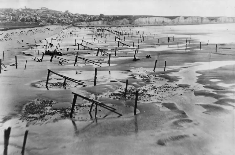 WW2-Men-and-horses-may-be-seen-working-amid-landing-obstructions-placed-along-the-Normandy-coast-as-part-of-the-Atlantic-Wall-Photo-taken-on-6th-May-1944-exactly-one-month-before-D-Day
