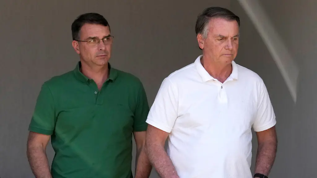 Former-President-Jair-Bolsonaro-right-and-his-son-Sen-Flavio-Bolsonaro-await-the-arrival-of-Sao-Paulo-Gov-Tarcisio-de-Freitas-at-his-home-where-he-is-under-house-arrest-in-Brasilia-Brazil-Monday-Sept-29-2025