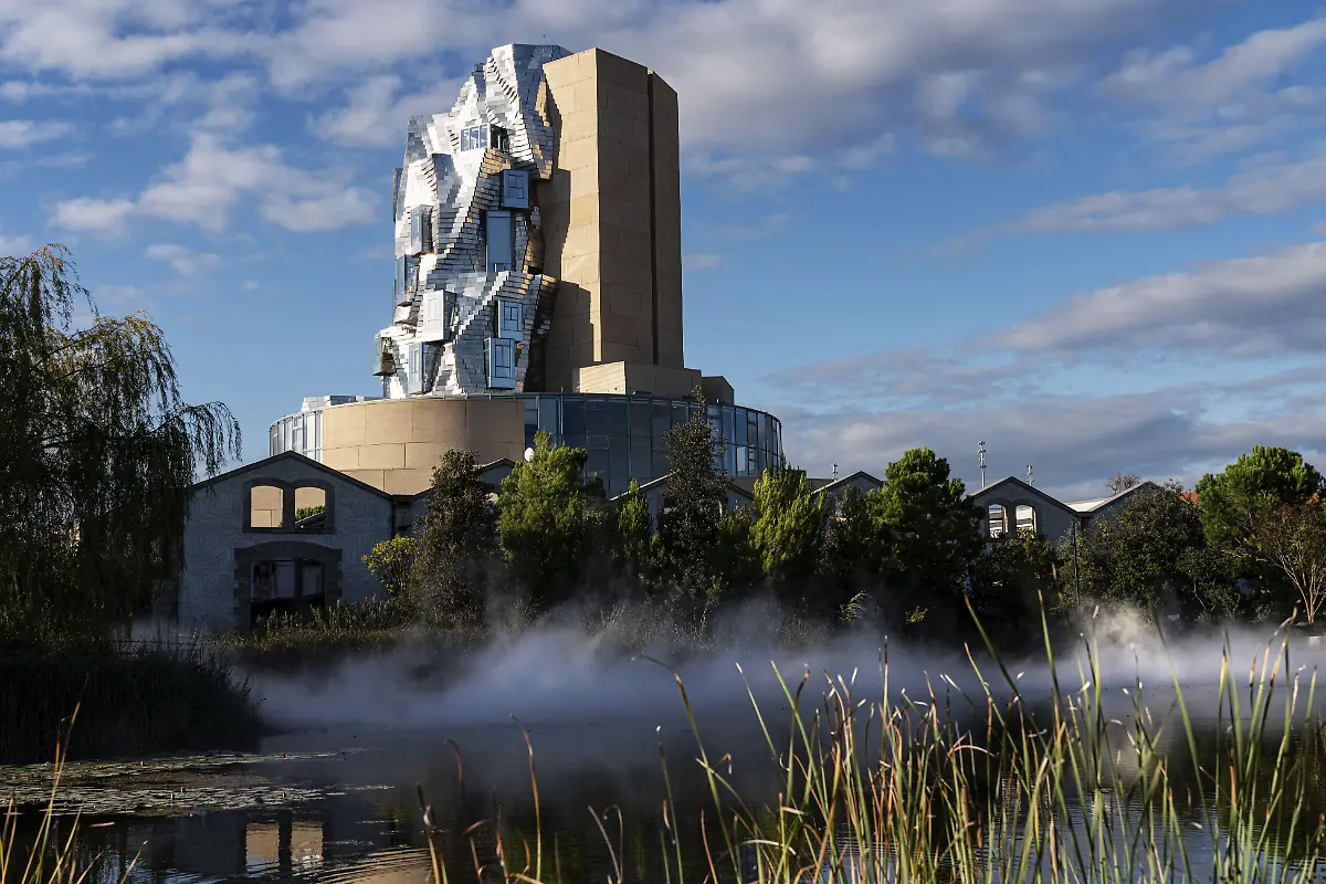 Vorne-See-mit-kuenstlichem-Nebel-Luma-56-m-hoher-unregelmaessiger-Turm-von-Frank-Gehry-entworfen-Turm-im-Stil-des-Dekonstruktivismus-Arles-Frankreich