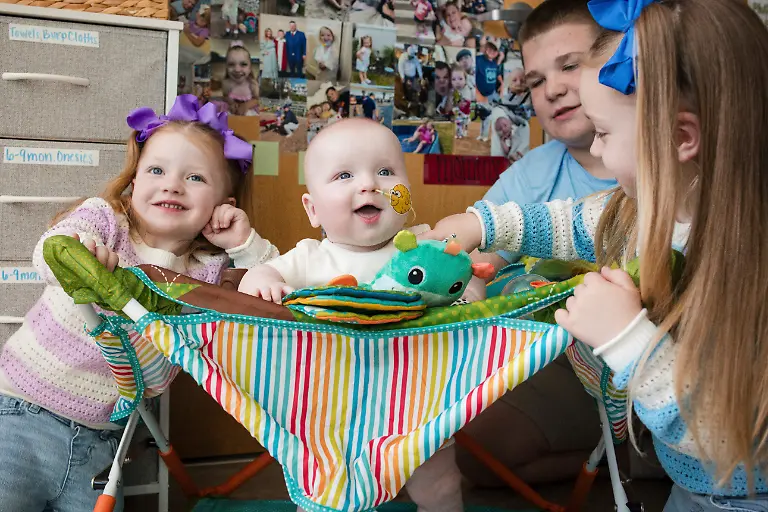 In-this-photo-provided-by-the-Children-s-Hospital-of-Philadelphia-KJ-Muldoon-center-sits-with-his-siblings-after-a-follow-up-dose-of-an-experimental-gene-editing-treatment-at-the-hospital-in-April-2025