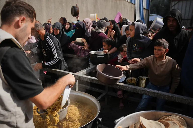 Palaestinenser-draengen-sich-um-gespendete-Lebensmittel-in-einer-Gemeinschaftskueche-in-Nuseirat-im-zentralen-Gazastreifen