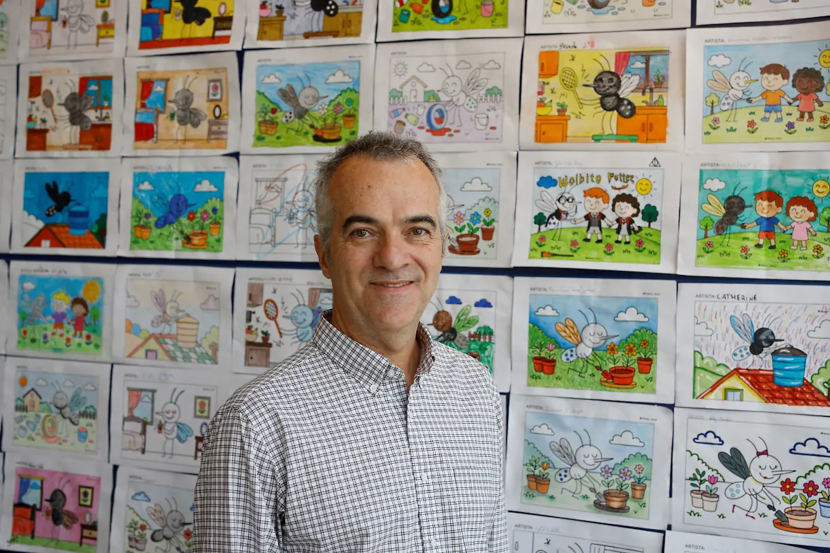 Luciano-Moreira-CEO-of-Wolbito-do-Brasil-poses-for-a-picture-near-children-s-colored-drawings-of-mosquitoes-in-Joinville-Santa-Catarina-state-Brazil-September-2-2025
