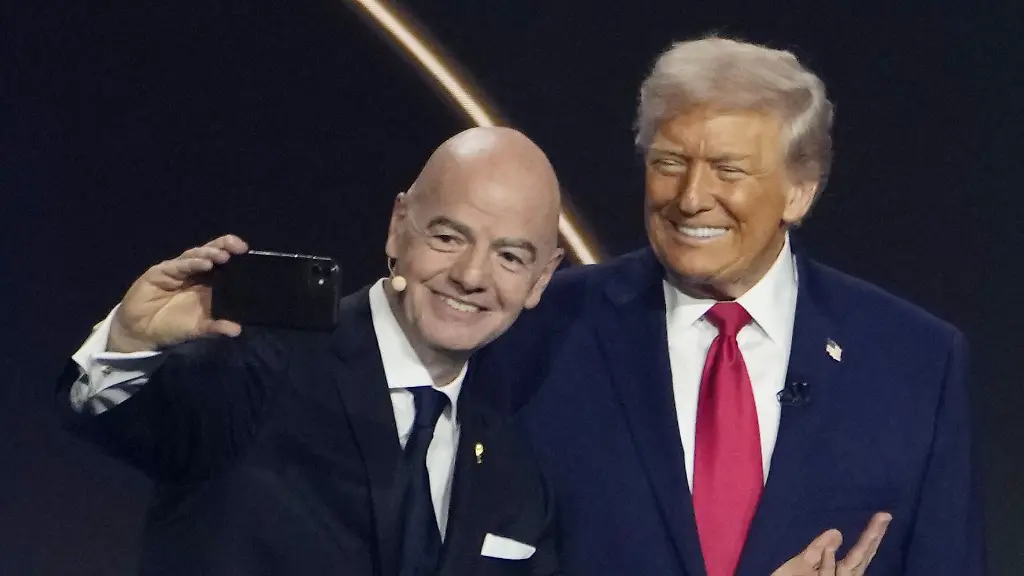 FIFA-President-Gianni-Infantino-L-takes-a-selfie-with-U-S-President-Donald-Trump-during-the-2026-World-Cup-official-draw-in-Washington-on-Dec-5-2025