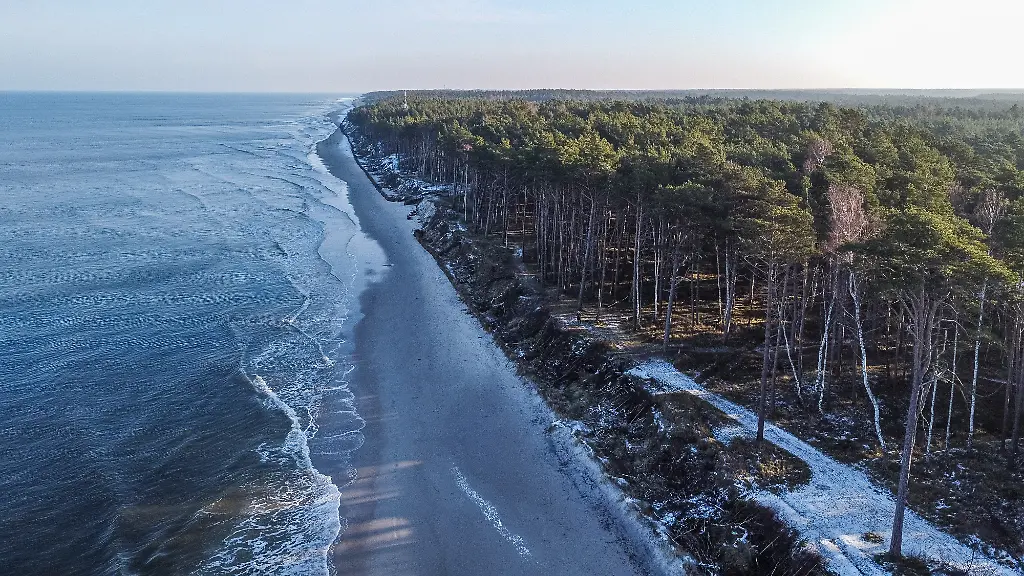 Aerial-view-of-the-Baltic-sea-coast-in-the-winter-scenery-where-the-nuclear-power-plant-will-be-located-is-seen-in-Lubiatowo-Choczewo-municipality-Poland-on-9-January-2022-The-seaside-villages-of-Lubiatowo-and-Kopalino-have-been-named-by-the-government-as-the-preferred-location-for-the-Polish-first-large-nuclear-power-plant