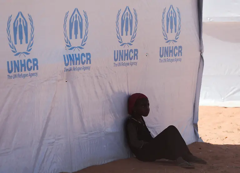 A-Sudanese-refugee-girl-from-Darfur-rests-beside-a-United-Nations-High-Commissioner-for-Refugees-UNHCR-tent-inside-the-Touloum-refugee-camp-amid-ongoing-conflict-in-their-country-on-the-outskirts-of-the-town-of-Iriba-in-Wadi-Fira-province-eastern-Chad-November-30-2025