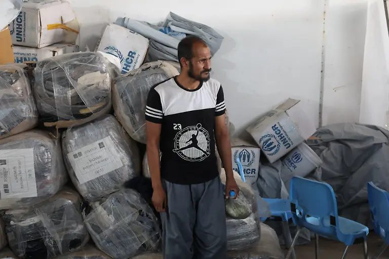 Mohammad-Akram-45-who-was-deported-from-Iran-and-separated-from-his-family-waits-to-receive-relief-items-from-UNHCR-at-a-camp-for-returning-migrants-near-the-Islam-Qala-border-crossing-in-Herat-province-Afghanistan-July-23-2025