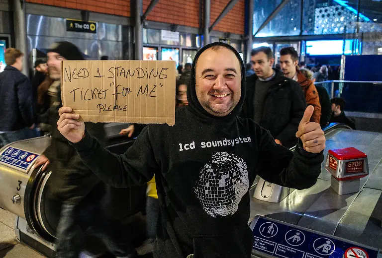 LONDON-ENGLAND-NOVEMBER-25-A-fan-appeals-for-a-ticket-outside-the-stadium-ahead-of-Radiohead-s-final-night-in-London-at-The-O2-Arena-on-November-25-2025-in-London-England