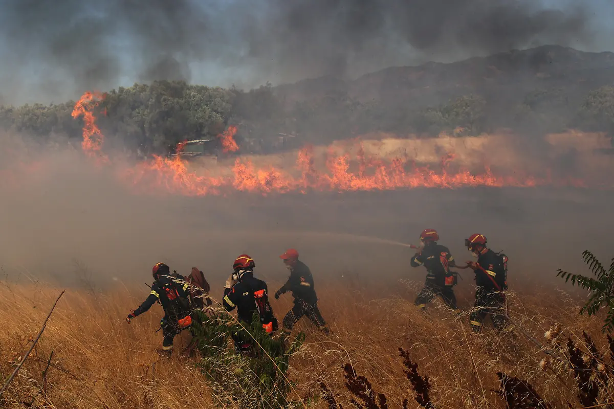 KOMOTINI-GREECE-AUGUST-10-Flames-and-smoke-rise-from-burning-trees-while-firefighters-continue-their-efforts-to-extinguish-the-fire-that-broke-out-in-the-forest-area-near-the-Komotini-Greece-on-August-10-2025-The-Kalkanca-neighborhood-located-approximately-3-kilometers-from-the-city-of-Komotini-in-Western-Thrace-where-a-densely-Turkish-population-lives-was-evacuated-due-to-a-fire-that-broke-out-in-a-forest-this-morning-Fire-crews-with-the-support-of-land-and-air-vehicles-are-working-intensively-to-prevent-the-flames-from-reaching-residential-areas