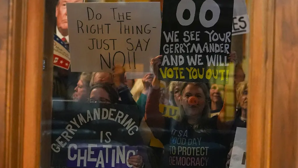 Protestors-are-seen-through-a-window-in-the-Senate-Chamber-during-dissuasion-before-a-vote-to-redistrict-the-state-s-congressional-map-Thursday-Dec-11-2025-at-the-Statehouse-in-Indianapolis