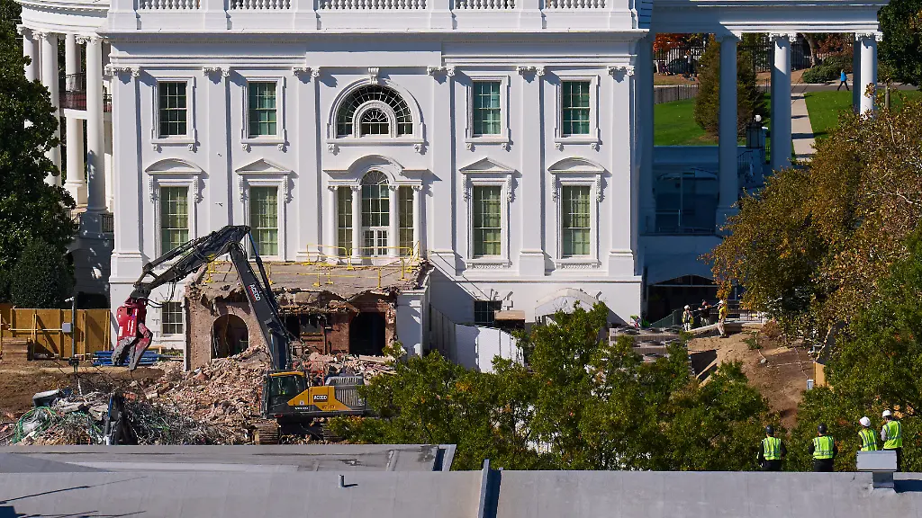 Construction-workers-bottom-right-atop-the-U-S-Treasury-watch-as-work-continues-on-a-largely-demolished-part-of-the-East-Wing-of-the-White-House-Thursday-Oct-23-2025-in-Washington-before-construction-of-a-new-ballroom