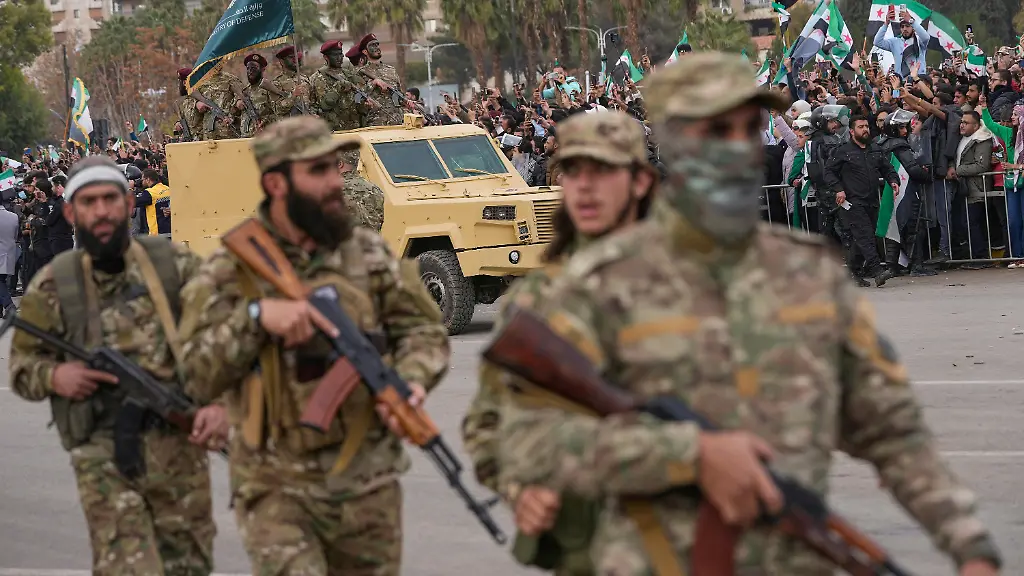 New-Syrian-army-soldiers-march-during-a-parade-marking-the-first-anniversary-of-the-ousting-of-former-President-Bashar-Assad-in-Damascus-Syria-Monday-Dec-8-2025